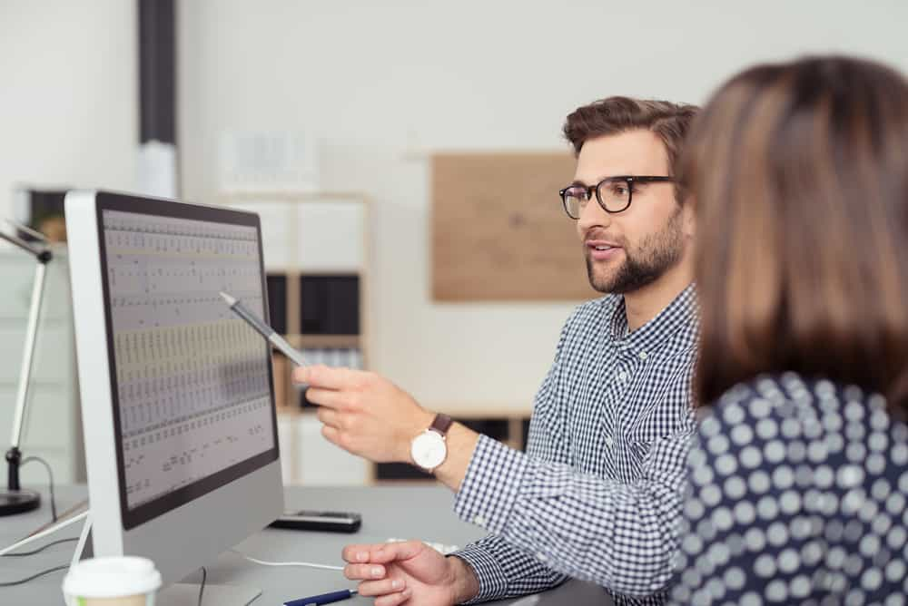 Colleagues working on a spreadsheet